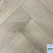 Canadian Standard Akita 12mm waterproof laminate flooring arranged in a classic herringbone pattern with realistic textured wood grain