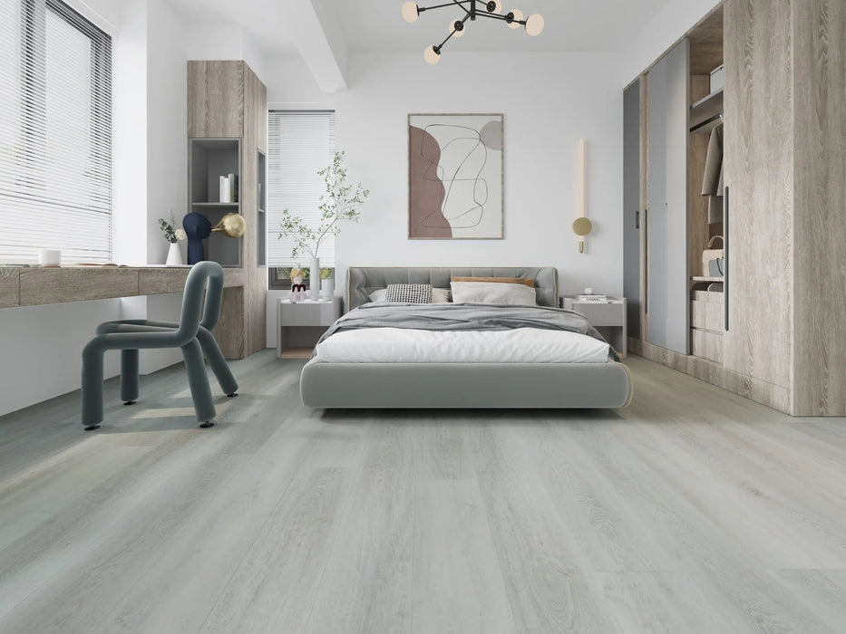 Canadian Standard Dawson Vanntett Plus 7mm waterproof SPC vinyl flooring featuring wide wood-look planks with realistic textured grain and a matte finish applied in a bedroom