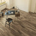 Canadian Standard EGGER PRO Gray Leoma Walnut 12mm laminate flooring featuring 7.6-inch wide planks with natural walnut-look wood grain in a room scene
