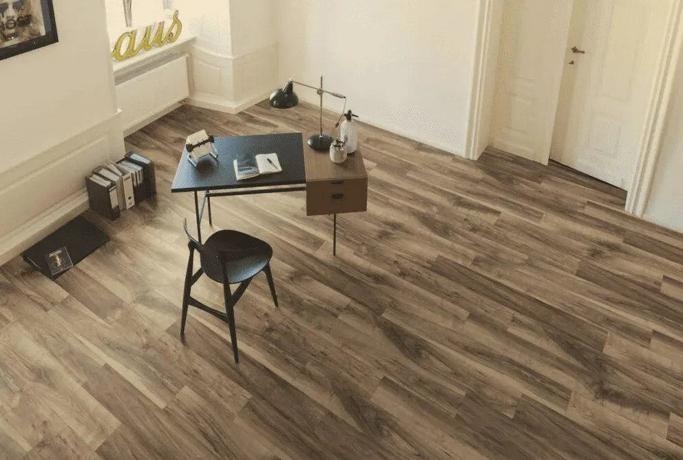Canadian Standard EGGER PRO Gray Leoma Walnut 12mm laminate flooring featuring 7.6-inch wide planks with natural walnut-look wood grain in a room scene