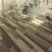 Canadian Standard EGGER PRO Gray Sorgono Pine 12mm laminate flooring featuring 7.6-inch wide planks with realistic pine-look wood grain in a room scene office
