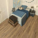 Canadian Standard EGGER PRO Valley Oak Mocca 12mm laminate flooring featuring 7.6-inch wide planks with natural oak-look grain texture in a bedroom