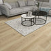 Canadian Standard Nikko Elemental12 waterproof laminate flooring featuring wide 9.29-inch wood-look planks with realistic grain and textured finish in a living room