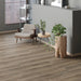 Canadian Standard Inhaus Elandura Caraway waterproof rigid core vinyl flooring featuring grey wood-look grain, medium colour variation and 6.81-inch-wide planks in a room scene