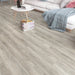 Canadian Standard Inhaus Elandura Clove 5mm waterproof rigid core vinyl flooring featuring medium taupe oak-look grain with medium tonal variation in a living room