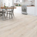 Canadian Standard Inhaus Elandura Seaside 5mm waterproof rigid core vinyl flooring featuring light white-toned wood grain with subtle tonal variation in a dining room and kitchen