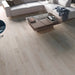 Canadian Standard Inhaus Elandura Silver Sand 5mm waterproof rigid core vinyl flooring featuring light grey oak-look grain with light tonal variation in a living room