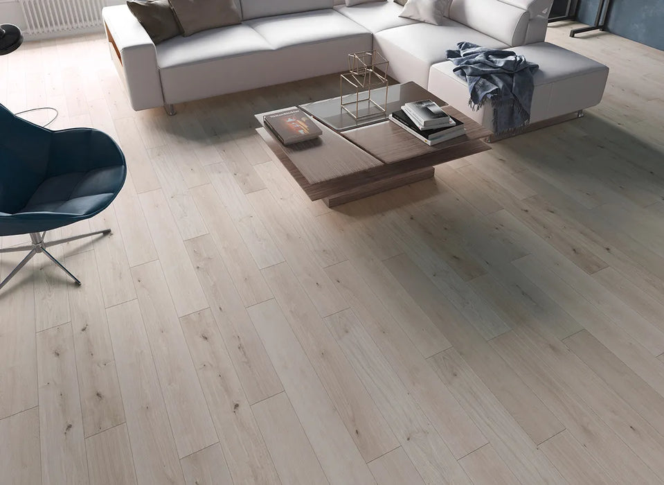 Canadian Standard Inhaus Elandura Silver Sand 5mm waterproof rigid core vinyl flooring featuring light grey oak-look grain with light tonal variation in a living room