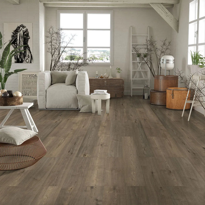 Canadian Standard Inhaus Elandura Tuscan 5mm waterproof rigid core vinyl flooring featuring dark brown wood-look grain with medium tonal variation in a living room