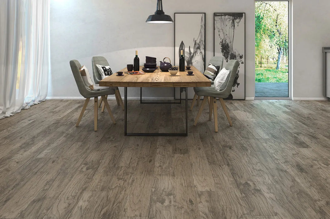 Canadian Standard Inhaus Inspiration Lamdura Folkstone 8mm water-resistant laminate flooring with handscraped embossed-in-register wood-grain texture in a dining room