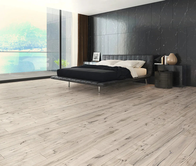 Canadian Standard Inhaus Inspiration Lamdura Sedgwick 10mm water-resistant laminate flooring featuring natural wood-look grain and 2mm attached pad in a bedroom