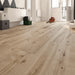 Canadian Standard Inhaus Inspiration Lamdura Woodside 10mm water-resistant laminate flooring with natural wood-look grain and 2mm attached acoustic pad in a room scene