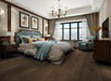 Canadian Standard Origins XL Charleston Oak engineered hardwood flooring featuring 7.5-inch wide planks with handscraped and wirebrushed texture in a bedroom