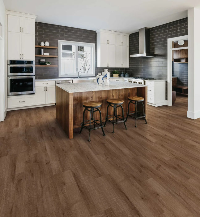 Canadian Standard Ridgecrest Five Peaks 8mm waterproof laminate flooring showing realistic wood grain, matte finish and painted micro-beveled plank edges in a dining room