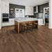Canadian Standard Ridgecrest Five Peaks 8mm waterproof laminate flooring showing realistic wood grain, matte finish and painted micro-beveled plank edges in a dining room