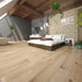 Canadian Standard SONO Eclipse Bower Oak 5.5mm flooring featuring 8-inch wide planks with realistic oak-look wood grain in a bedroom