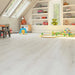 Canadian Standard SONO Eclipse Winter Oak flooring featuring 8-inch wide planks with natural oak-look wood grain in a bedroom