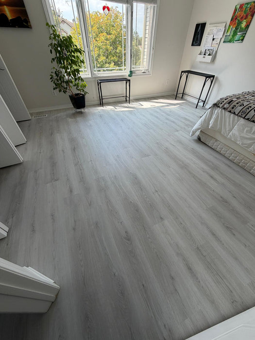 NAF AquaPlus Classic Punta Cana 7mm waterproof rigid core vinyl plank flooring with textured finish and click-lock installation applied in a bedroom