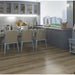 NAF AquaPlus Gold with Cork Shangri-La 7mm waterproof SPC vinyl plank flooring with textured wood grain and attached cork backing in a dining room