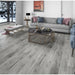 NAF AquaPlus Gold with Cork Siberia 7mm waterproof SPC vinyl plank flooring with textured wood grain and attached cork backing in a living room