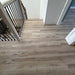 NAF AquaPlus Gold Lakeshore 7mm waterproof rigid core vinyl plank flooring with realistic wood grain and deep-textured finish applied at home