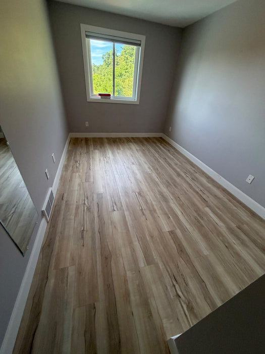 NAF AquaPlus Gold Lakeshore 7mm waterproof rigid core vinyl plank flooring with realistic wood grain and deep-textured finish room application sample