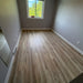NAF AquaPlus Gold Lakeshore 7mm waterproof rigid core vinyl plank flooring with realistic wood grain and deep-textured finish room application sample