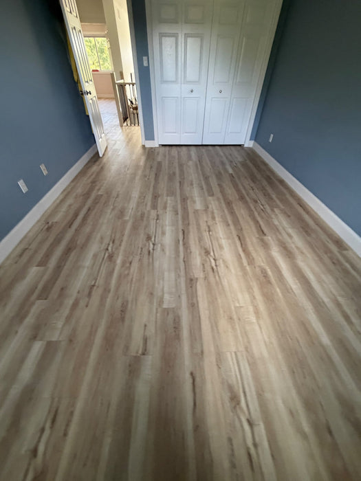 NAF AquaPlus Gold Lakeshore 7mm waterproof rigid core vinyl plank flooring with realistic wood grain and deep-textured finish in a room scene