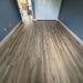 NAF AquaPlus Gold Lakeshore 7mm waterproof rigid core vinyl plank flooring with realistic wood grain and deep-textured finish in a room scene
