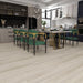 NAF AquaPlus Gold Russell Hill 7mm waterproof rigid core vinyl plank flooring with realistic wood grain and deep-textured finish in a dining room