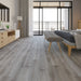 NAF AquaPlus Select Bay 7mm waterproof rigid core vinyl plank flooring with realistic wood grain and deep-textured finish applied in a bedroom