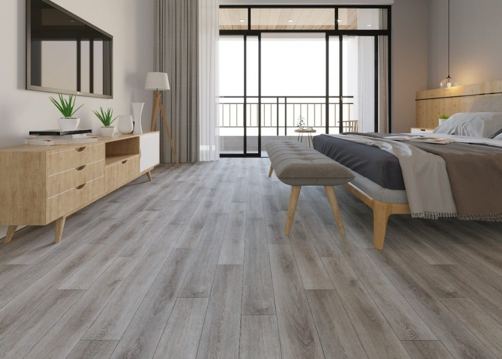 NAF AquaPlus Select Bay 7mm waterproof rigid core vinyl plank flooring with realistic wood grain and deep-textured finish applied in a bedroom