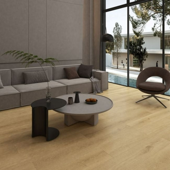 NAF Electra 12mm waterproof laminate PLUS flooring featuring wide 9.3-inch wood-look planks and textured surface detailing in a living room