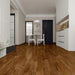 NAF Heritage Maple 14mm waterproof laminate flooring featuring 7.7-inch wood-look planks with a realistic 4D textured finish in a living room