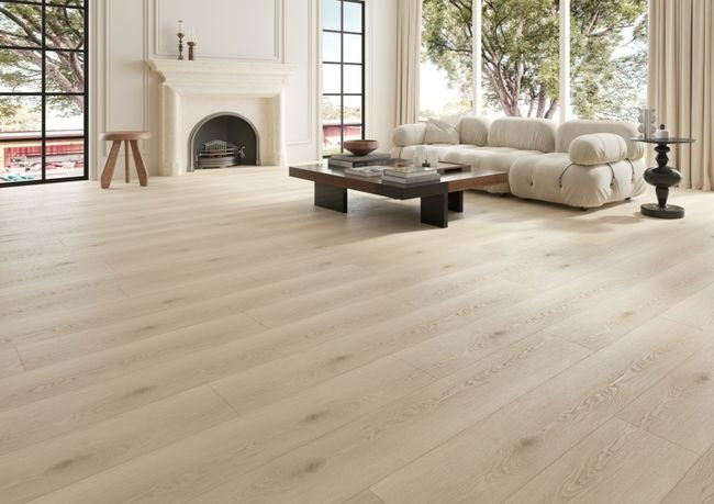 NAF Luna 12mm waterproof laminate PLUS flooring featuring 9.3-inch-wide wood-look planks with realistic 4D texture in a living room